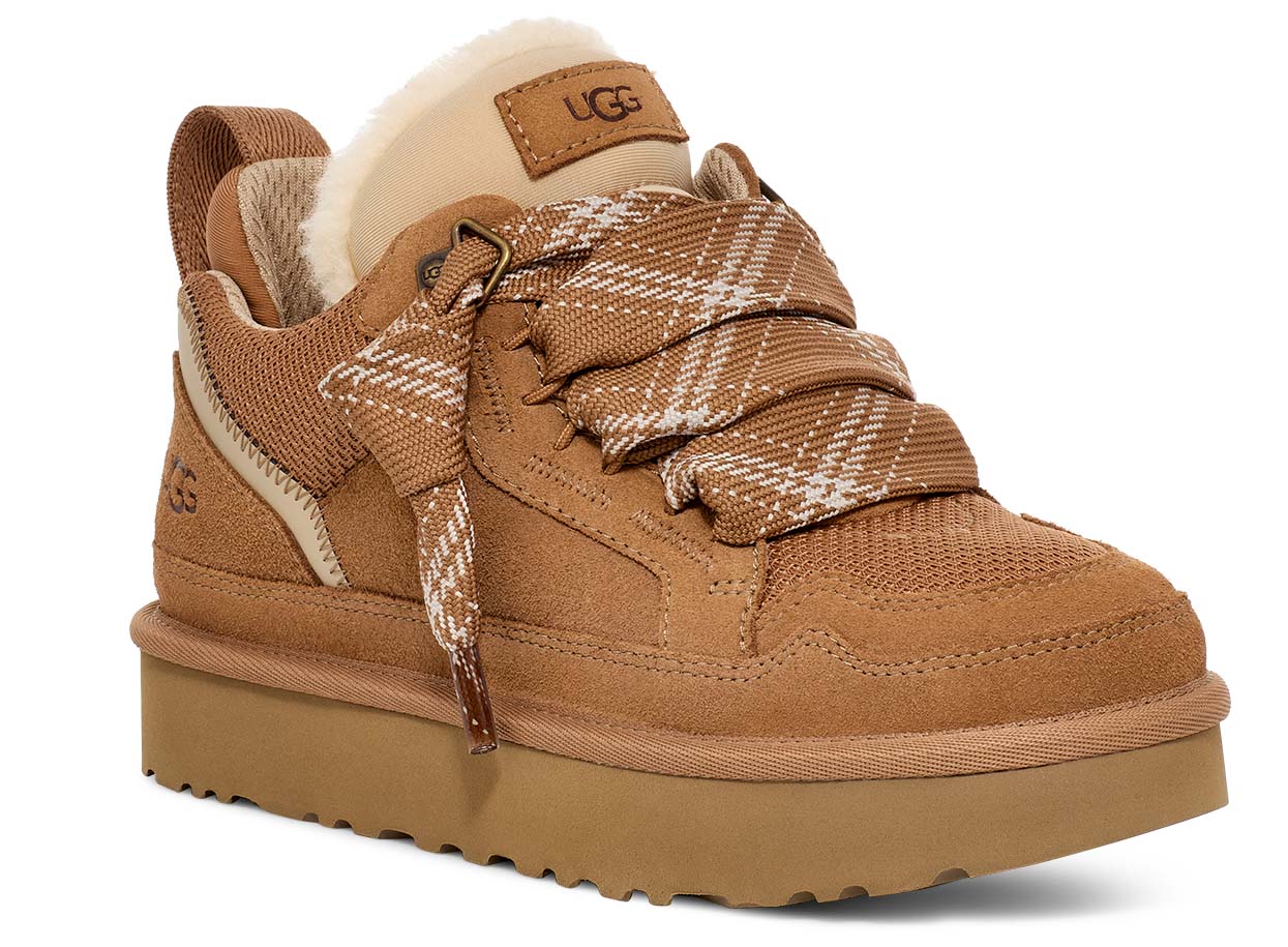 Tan suede sneaker with a thick sole and a plaid, wide lace-up closure and a tan patch that reads UGG.