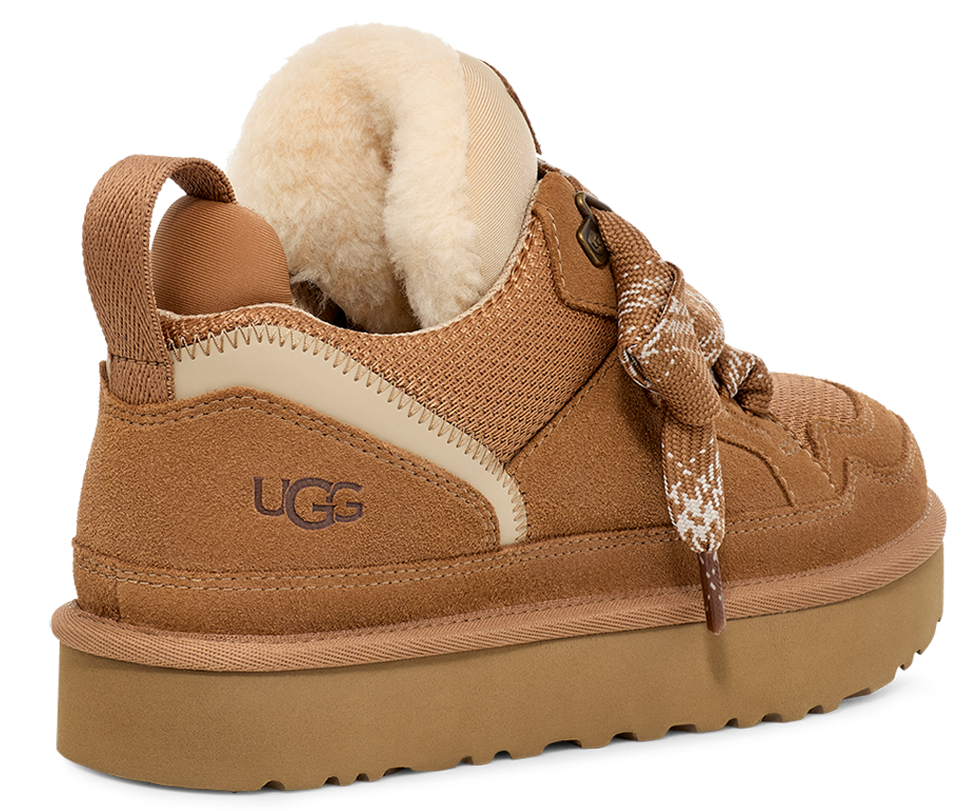 A low-cut light-brown shoe with shearling cuff, laces, and a thick sole. It has UGG written on the back.