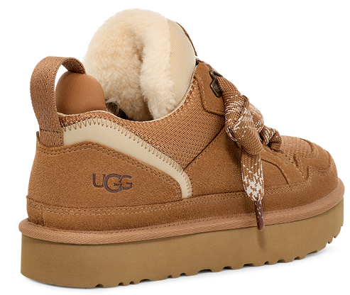 A low-cut light-brown shoe with shearling cuff, laces, and a thick sole. It has UGG written on the back.