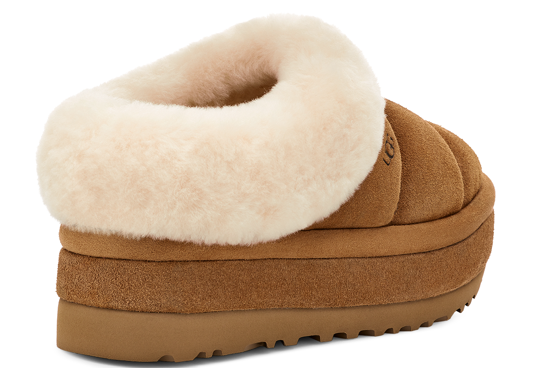 Low-rise platform slipper with suede upper and sheepskin trim.