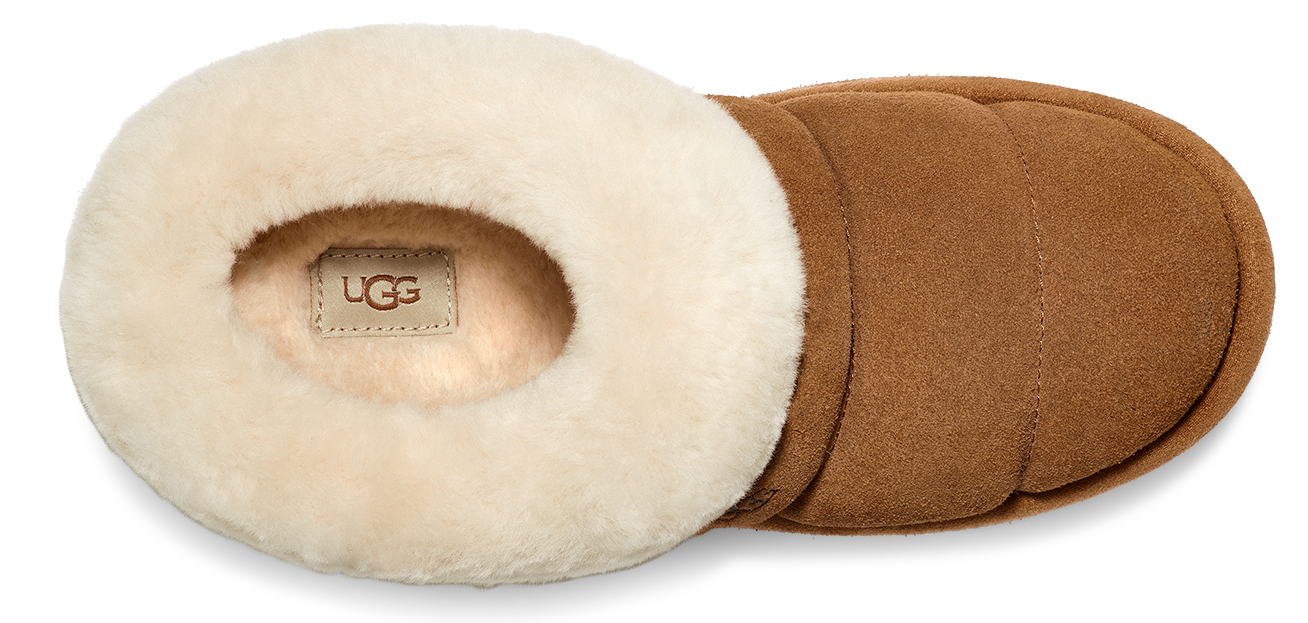 A tan UGG slipper with a cream-colored plush lining.
