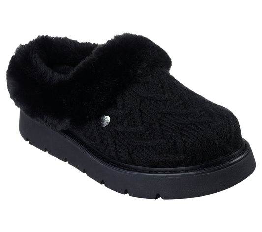 Black knit slipper with faux fur trim and platform sole.