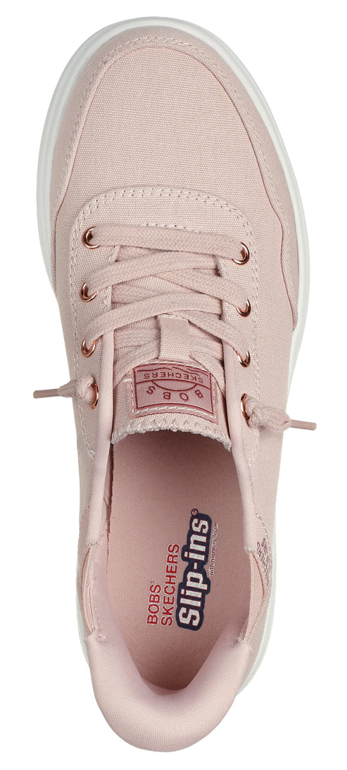A pink low-top sneaker with white soles, lace-up closure, and "Slip-ins" text printed on the inner sole.