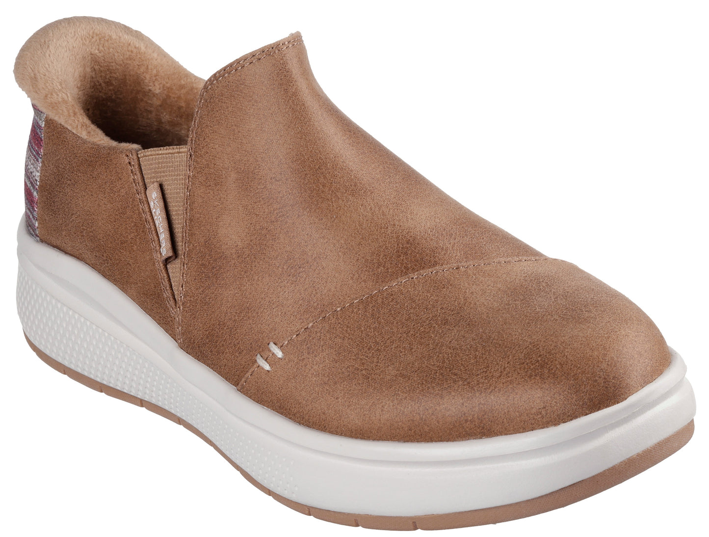 Slip-on shoe with brown upper, white sole and elastic at the side.