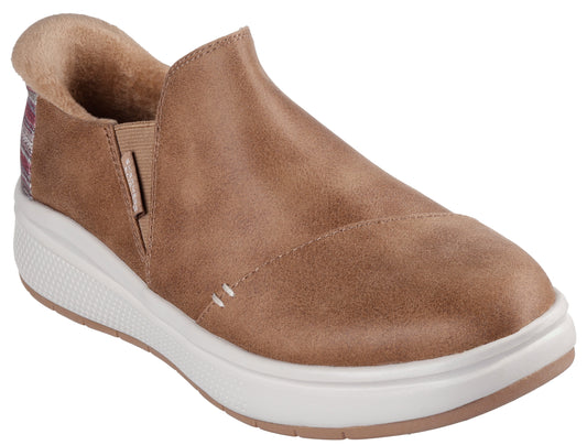 Slip-on shoe with brown upper, white sole and elastic at the side.