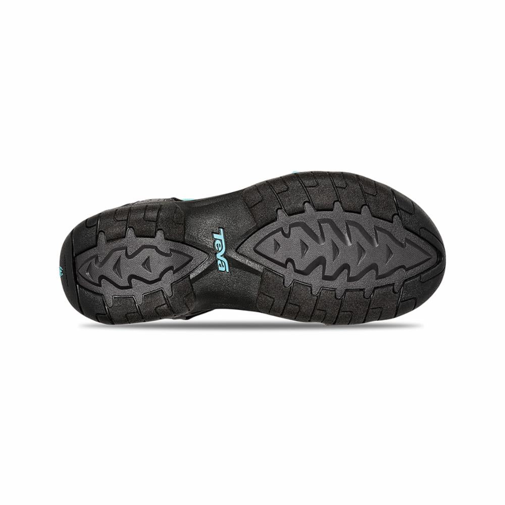 Bottom view of a black sandal with a textured gray sole and blue logo.