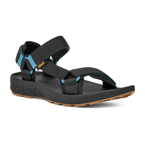 A black sandal with a thick sole and black and blue straps.