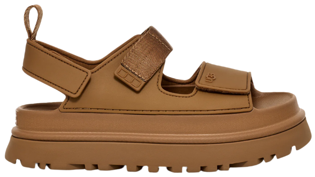 Brown sandal with velcro straps and thick lug sole.