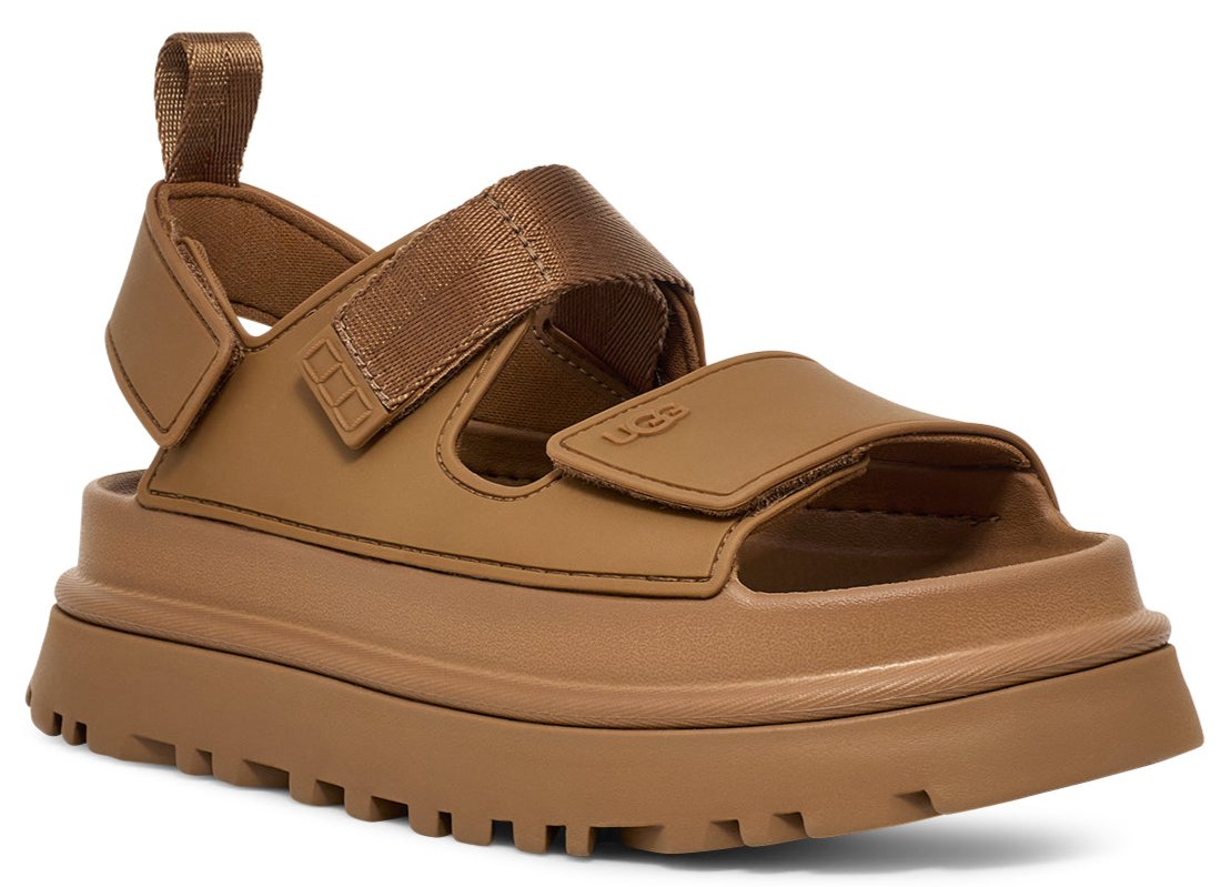 A light brown sandal with hook-and-loop straps on a chunky sole.