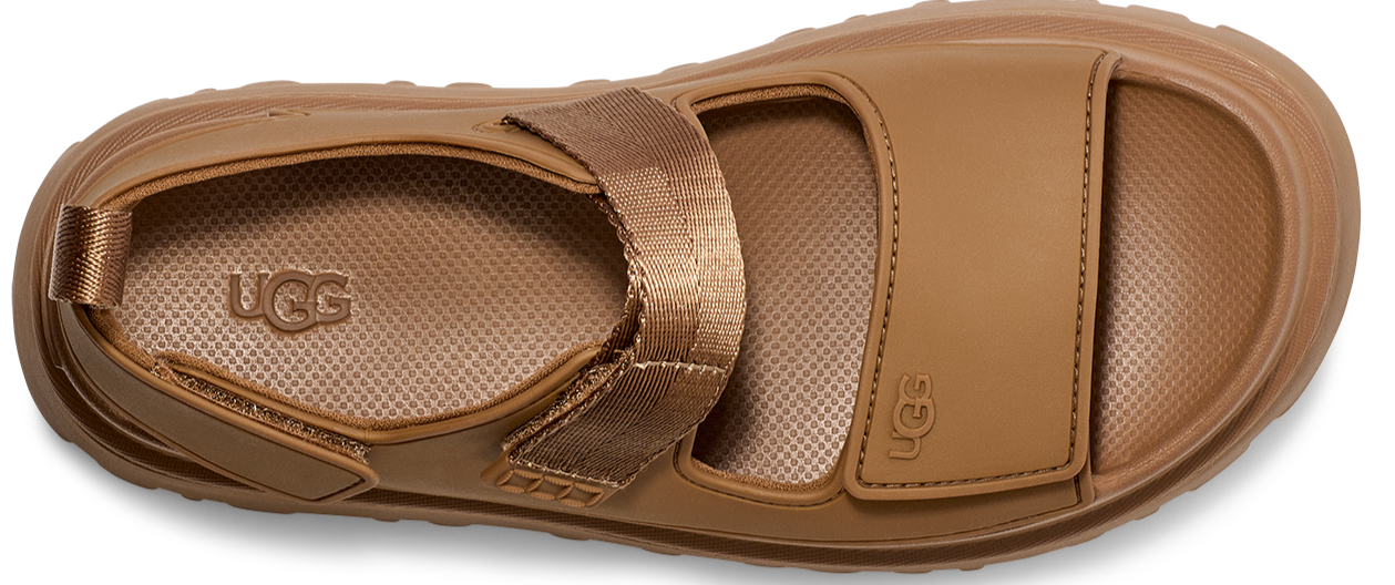 Flat sandal with a lug sole and wide straps, one of which is textile.