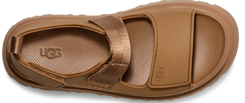 Flat sandal with a lug sole and wide straps, one of which is textile.
