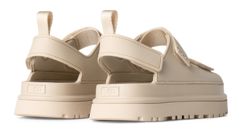 A pair of platform sandals in cream color with adjustable velcro strap.