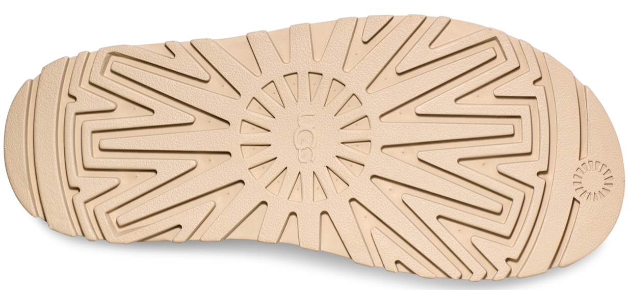 tan shoe sole with a textured pattern and the UGG logo in the center