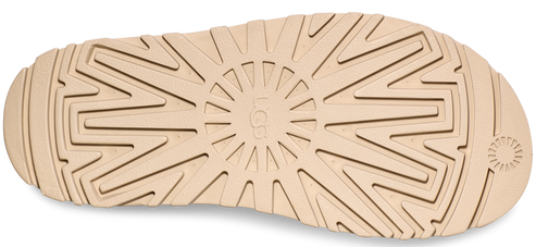 tan shoe sole with a textured pattern and the UGG logo in the center