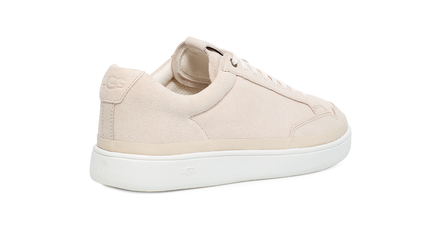 Tan-colored leather sneaker with a white sole and rounded toe.