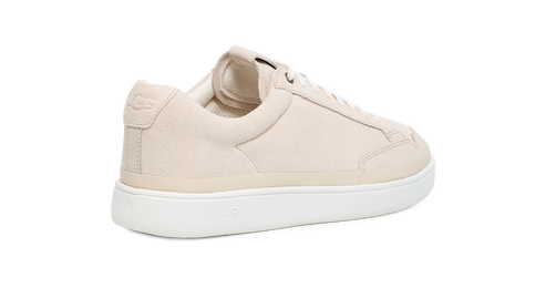 Tan-colored leather sneaker with a white sole and rounded toe.