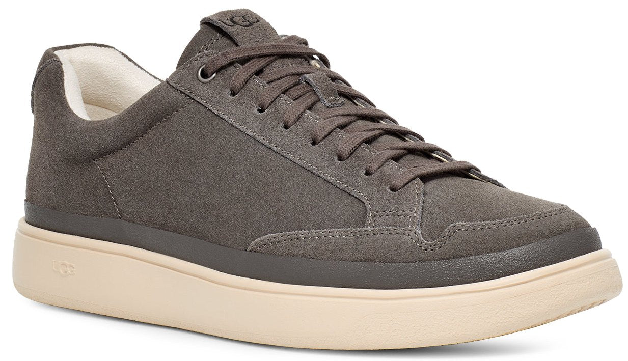 A low-top sneaker with gray suede upper, lace-up closure, and beige sole.