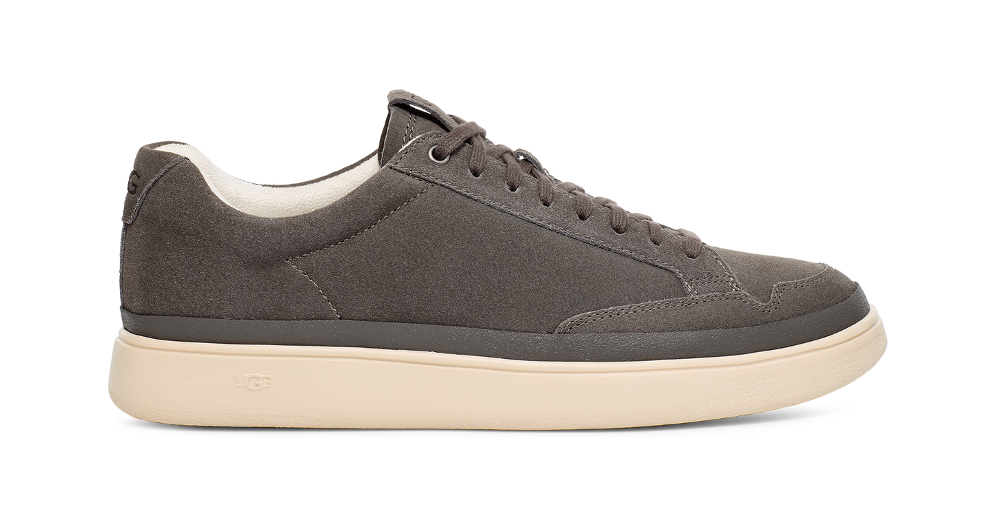 Low-top gray sneaker with a white sole.