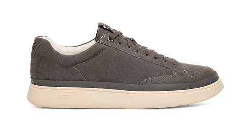 Low-top gray sneaker with a white sole.
