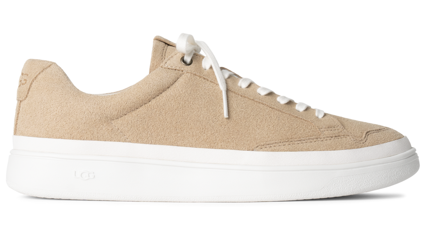 Beige suede sneaker with white laces and a thick white sole.