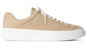 Beige suede sneaker with white laces and a thick white sole.