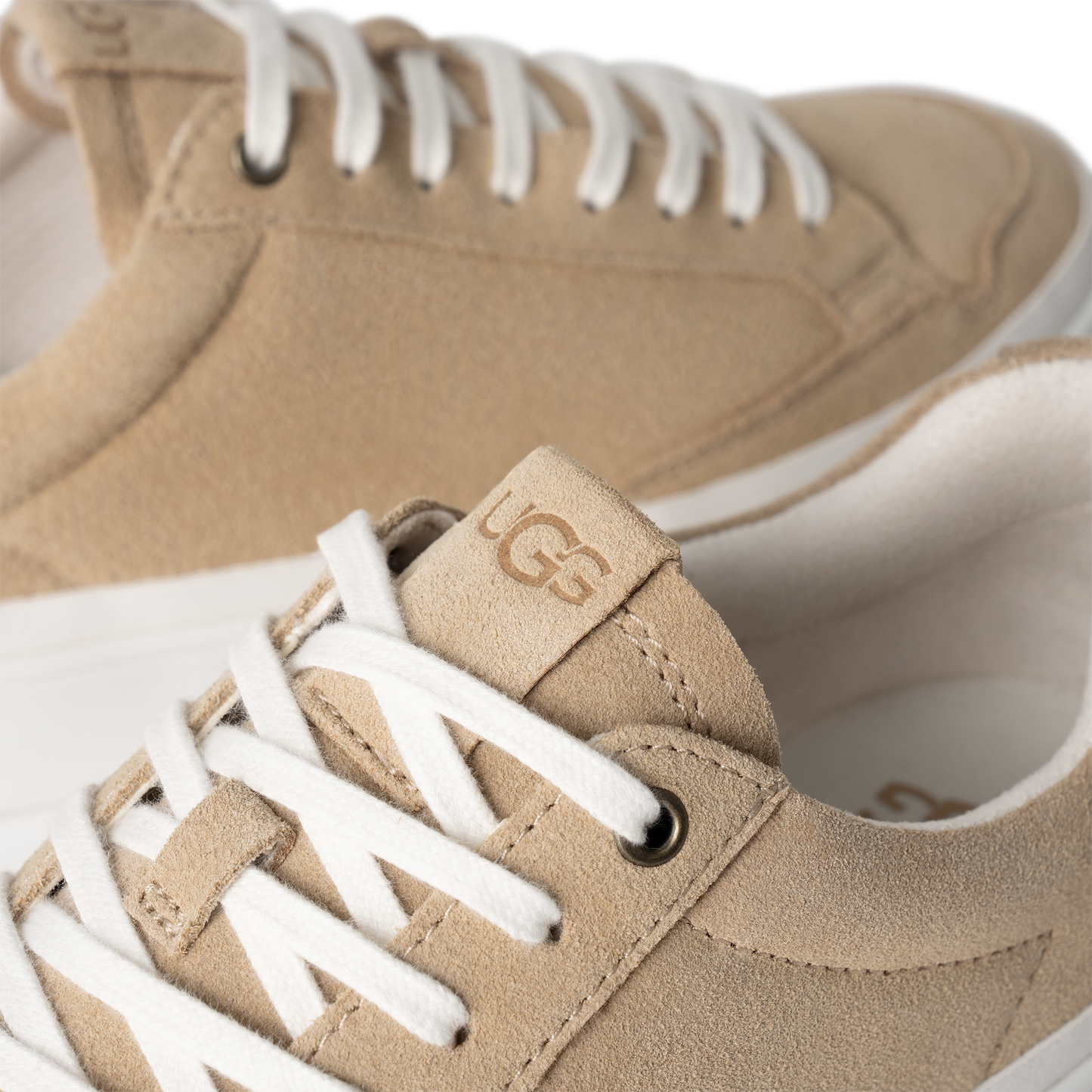 Low-top suede sneaker with the logo "UGG" on the tongue and white laces.