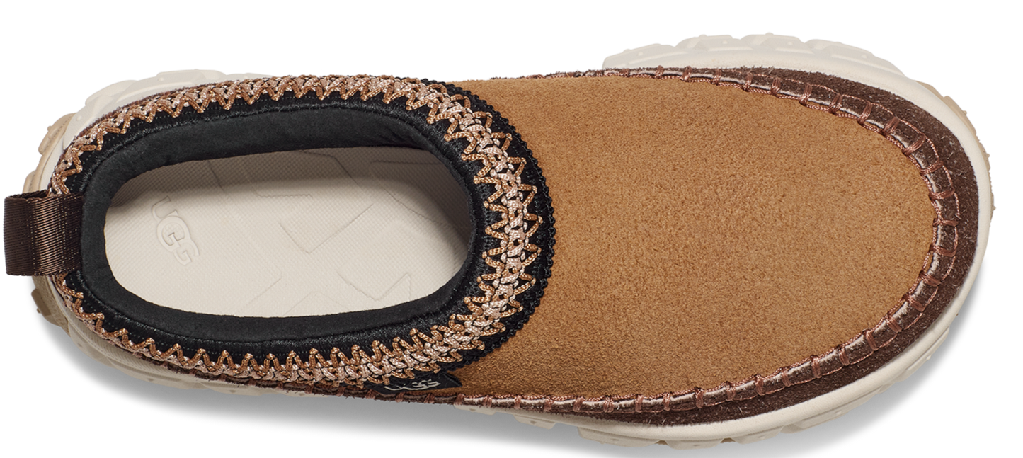 Tan slip-on shoe with a thick cream sole and dark brown trim.