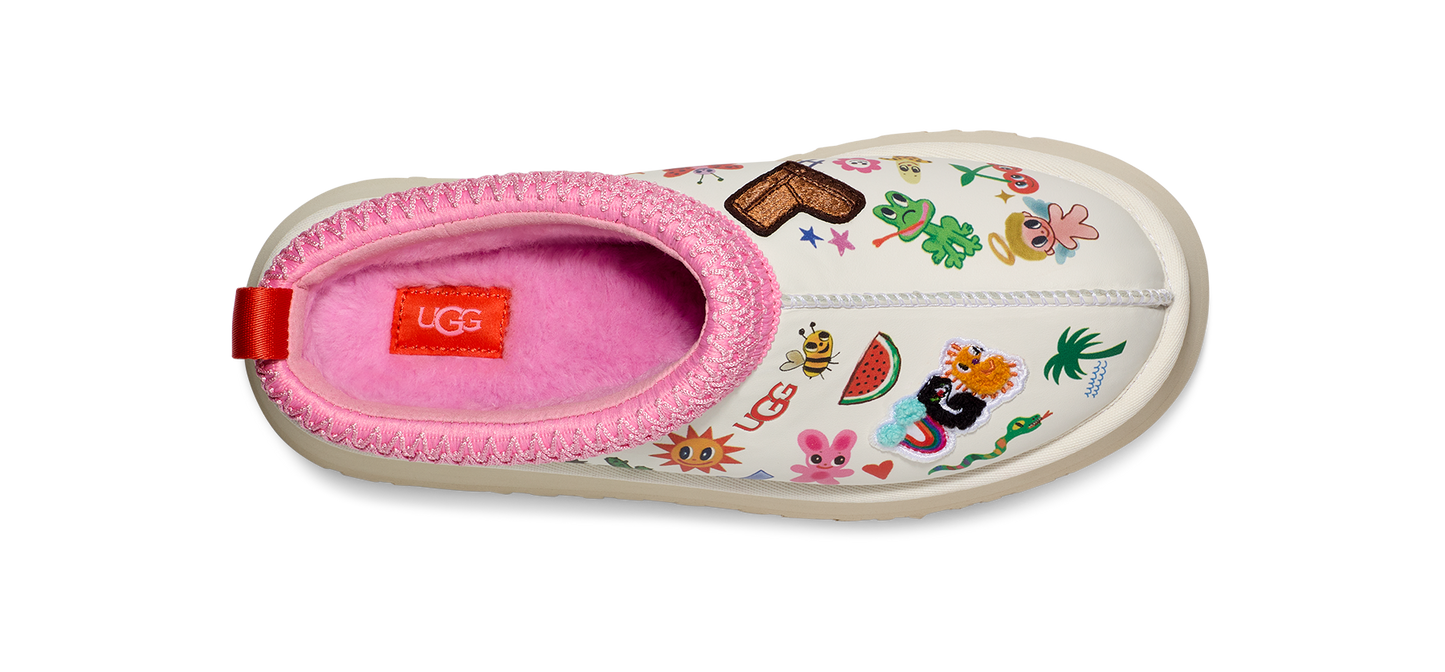 A slipper with a pink fur lining and a white exterior decorated with various cartoon-like images.