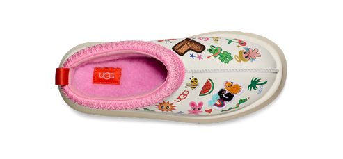 A slipper with a pink fur lining and a white exterior decorated with various cartoon-like images.