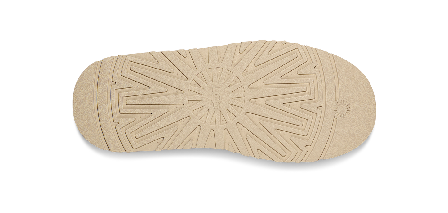The sole of a shoe featuring a circular traction pattern.