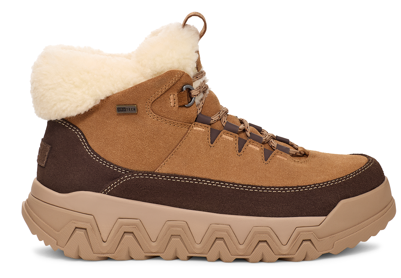Tan hiking boot with a brown band near the sole and fur at the ankle.