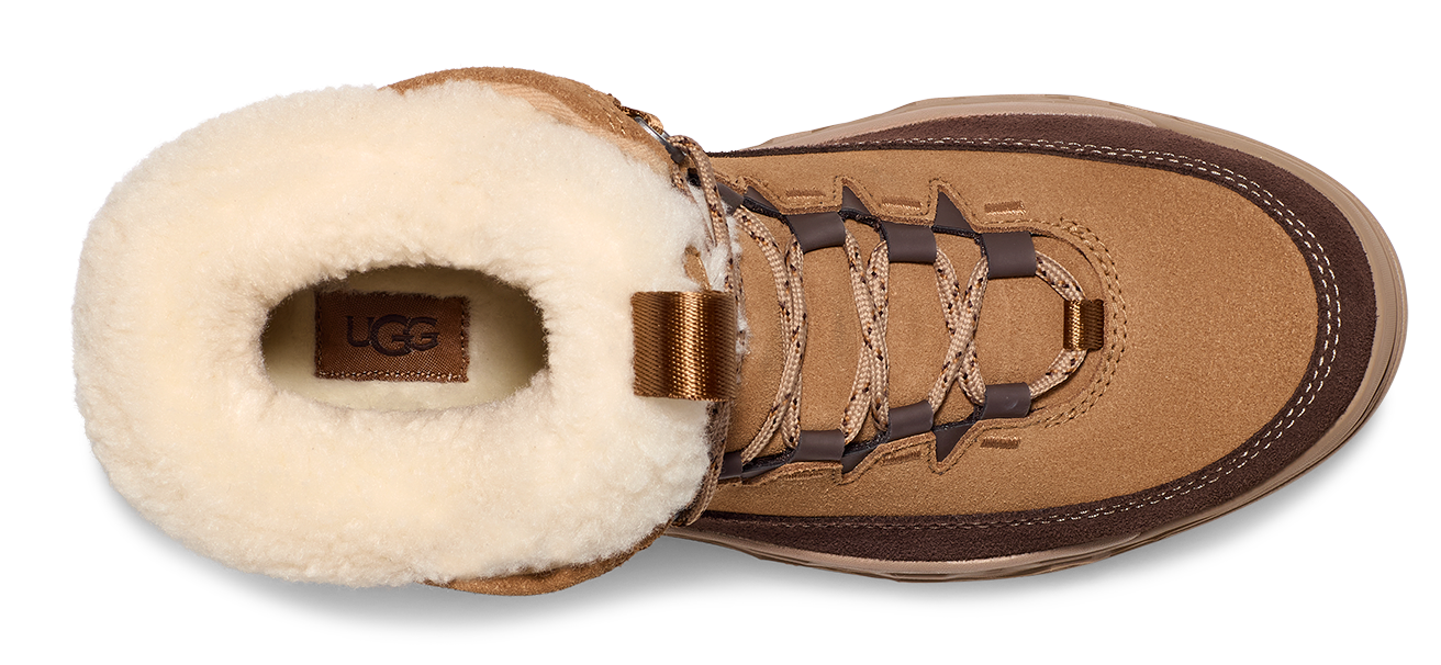 Tan boot with cream-colored sheepskin lining and a visible UGG logo.