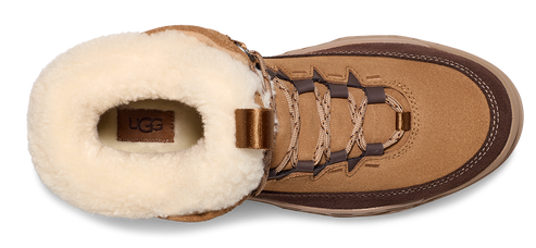 Tan boot with cream-colored sheepskin lining and a visible UGG logo.