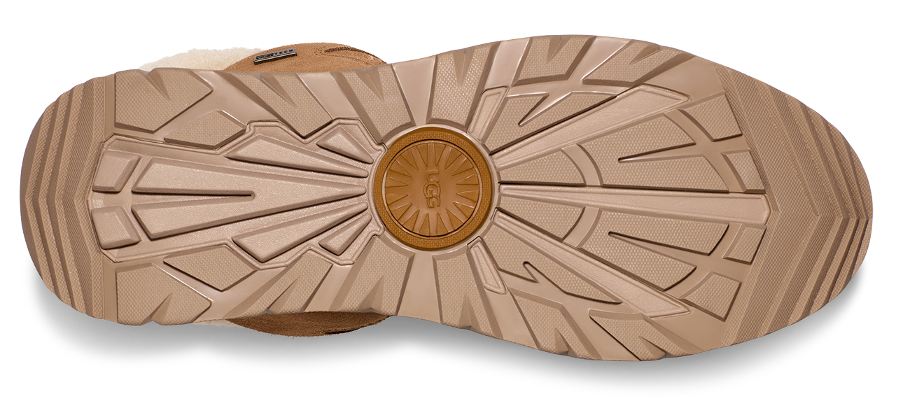Sole of a shoe with intricate radial and linear treads, featuring a circular logo at the center.
