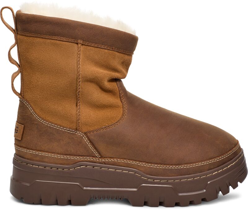 Brown leather boot with exposed faux fur lining and a thick treaded sole.