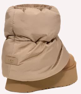 Platform boot with a beige puffy nylon upper and embossed logo.