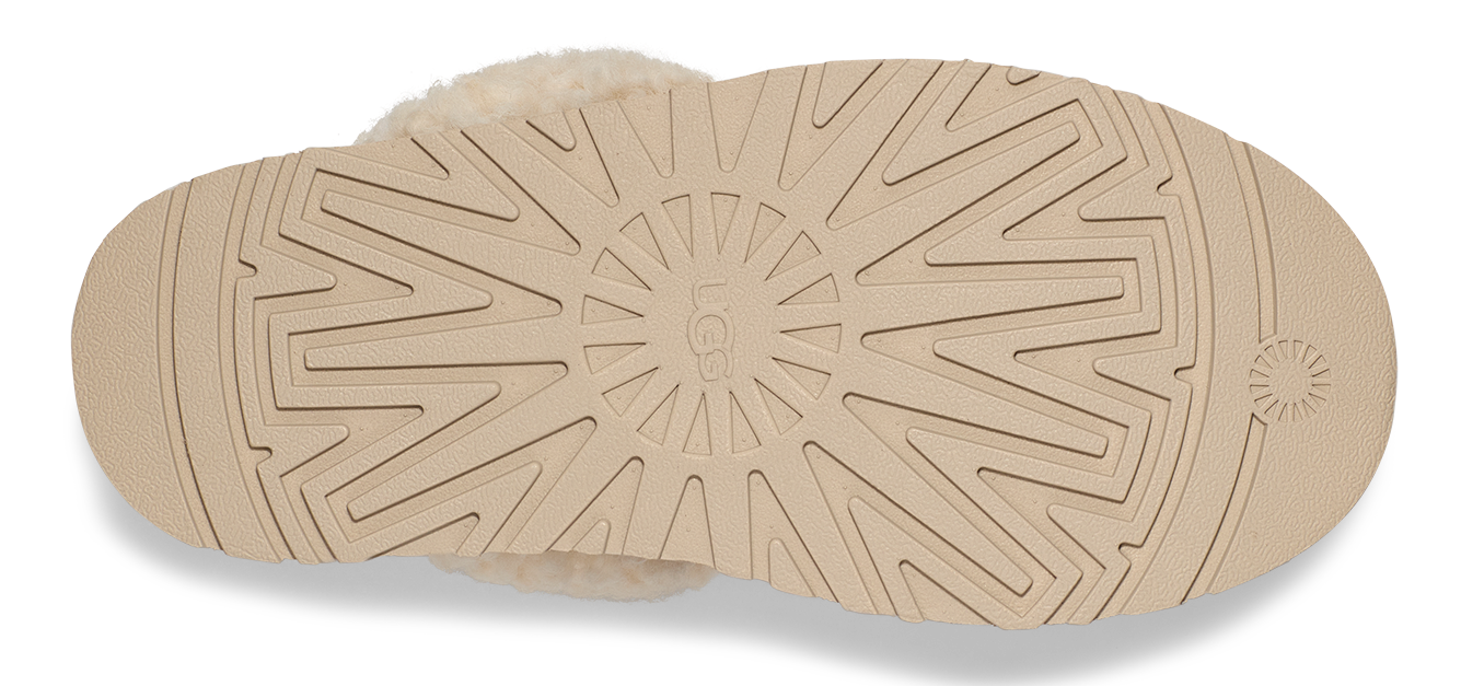 Tan slipper sole with geometric and concentric circle tread.