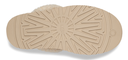 Tan slipper sole with geometric and concentric circle tread.