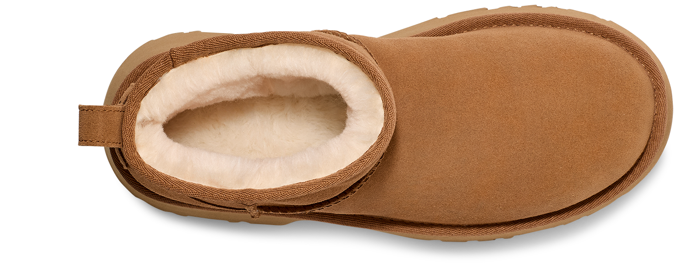 Tan-colored boot with a round toe and white fur lining.