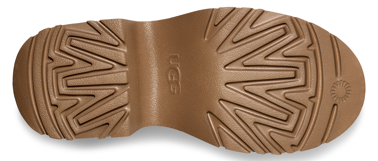 a light brown lug outsole with the letters "UGG" on the arch