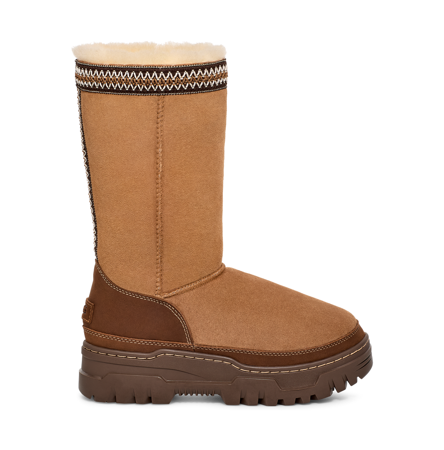 A brown suede-like tall UGG boot with a brown sole and patterned top.