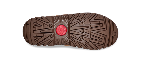 Bottom of boot with geometric treads and circular logo in center.