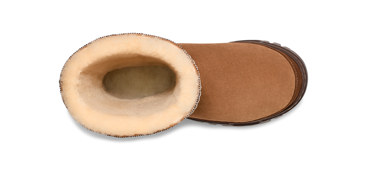 An open, tan-colored UGG boot displays its tan sole and fluffy lining.