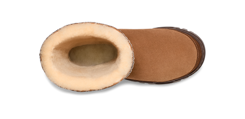 An open, tan-colored UGG boot displays its tan sole and fluffy lining.