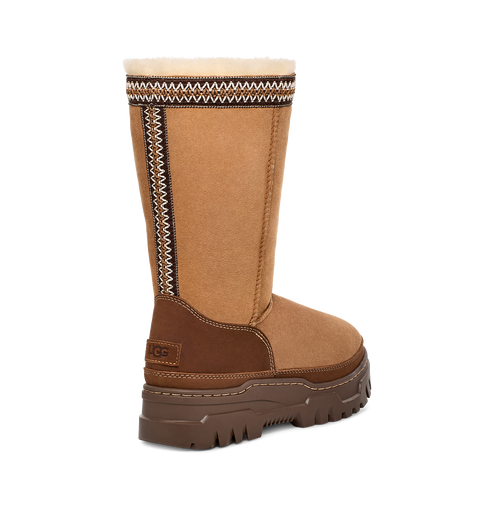 A mid-calf brown boot with a light brown and dark brown pattern around the top edge.