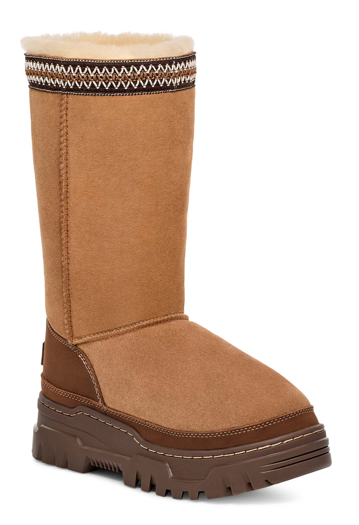 Tall brown boot with lug sole and patterned collar.