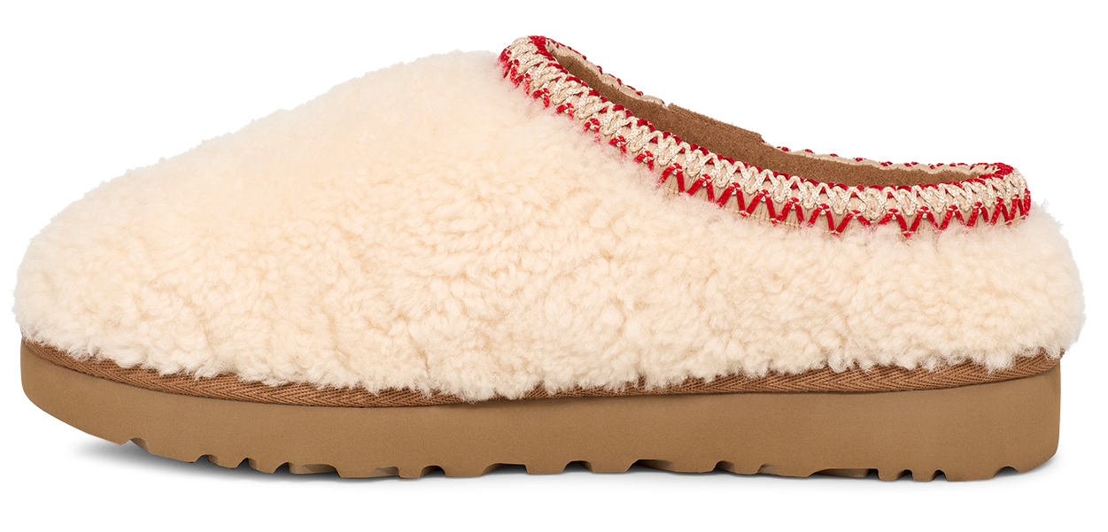 A cream-colored, fluffy, slipper with a brown sole.