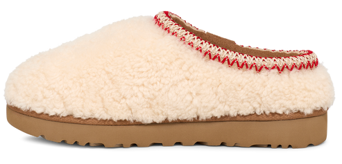 A cream-colored, fluffy, slipper with a brown sole.
