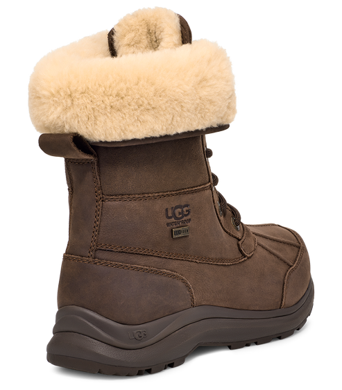Brown waterproof UGG boot with tan fur cuff and dark laces.