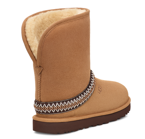 Tan short boot with exposed sheepskin lining and patterned ankle band.